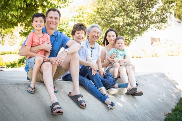 family sitting on a curb